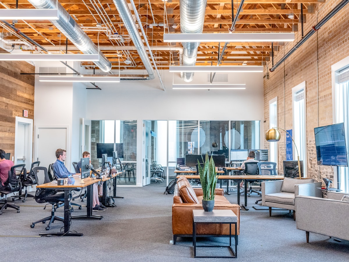 Modern workspace with multiple monitors in a collaborative office environment